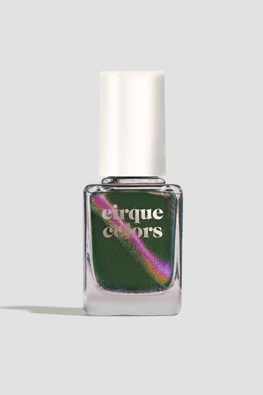 Cirque Colors Folie à Deux forest green nail polish bottle with magenta, green, and gold multichrome magnetic pigment