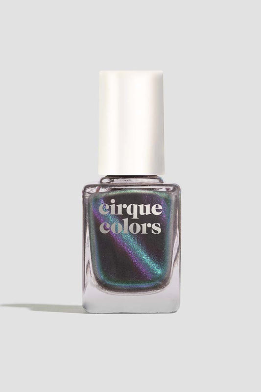 Bottle of Cirque Colors Wishful Thinking smoke-gray nail polish bottle with aqua, blue, and violet multichrome magnetic shimmer.