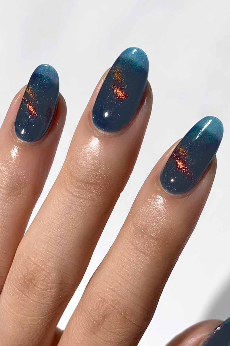 Magnetic nail art design using Cirque Colors Castle in the Sky teal blue polish with red-bronze multichrome shimme