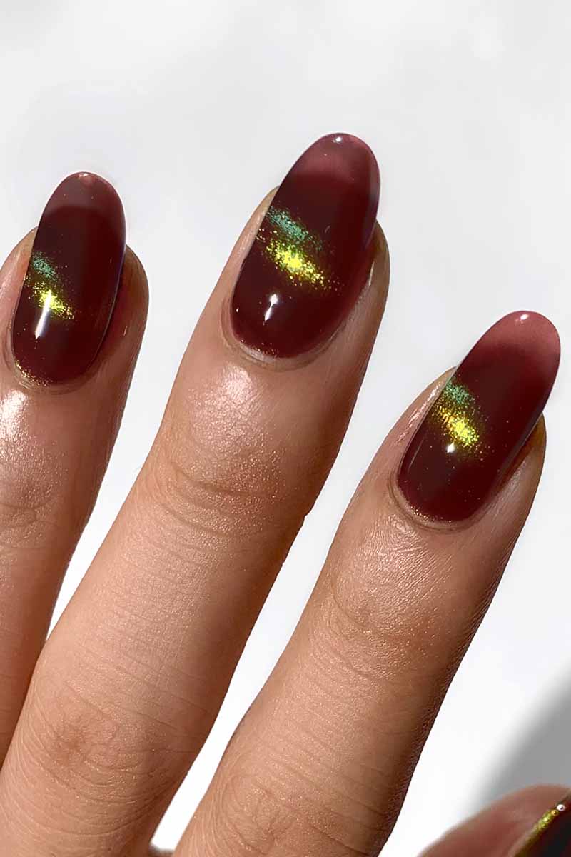 Cirque Colors Delusions of Grandeur oxblood red magnetic multichrome nail polish with bronze, gold, and green shimmer on nails