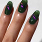 Cirque Colors Folie à Deux forest green magnetic nail polish with 3D magenta, green, gold multichrome pigment on nails